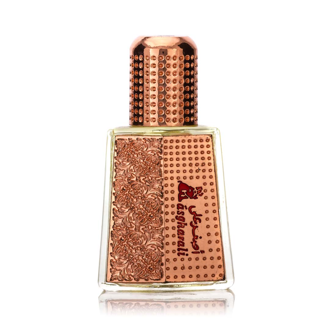 A bottle of Ward Attar fragrance oil with a rose gold-colored cap and a textured, embossed surface.