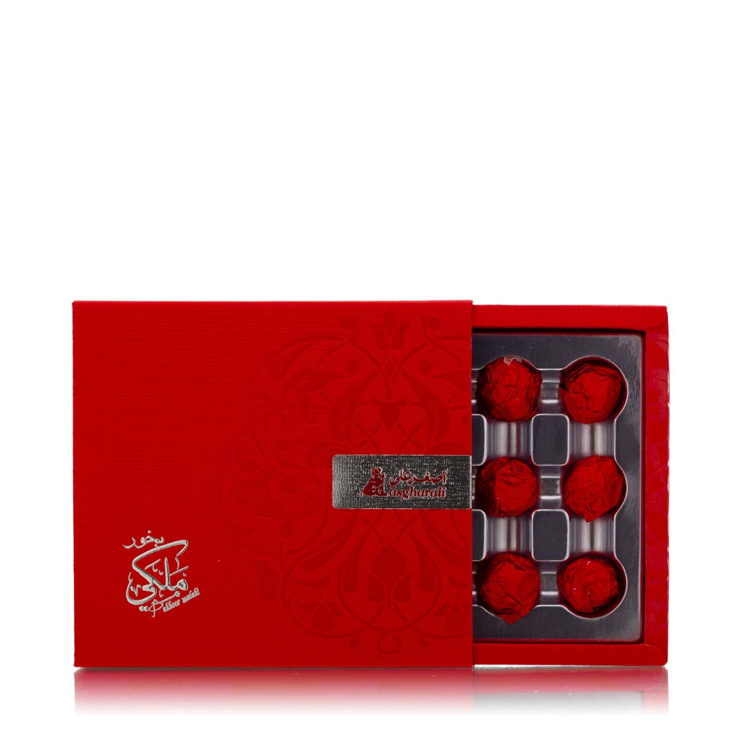 Open box showing bakhoor pieces arranged in separate compartments