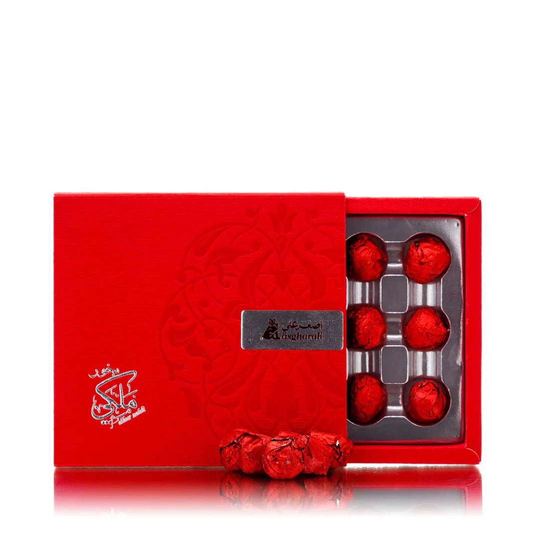 A red box of Bakhoor Al Malaki incense cones with a floral pattern and the product name displayed on the box.