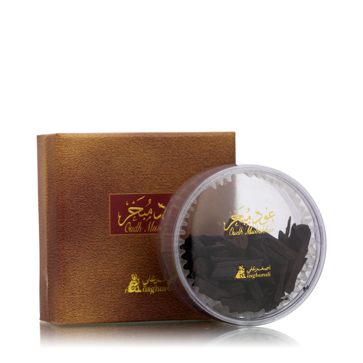 Oud Mubakhar 15g product display with brown textured box and transparent round container showcasing dark oud chips